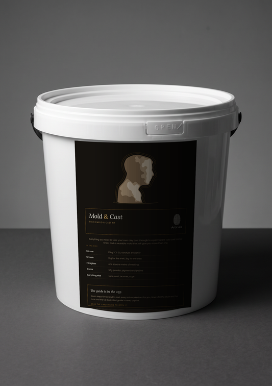 Articulis Mold and Cast Kit bucket with its label, on a grey studio background